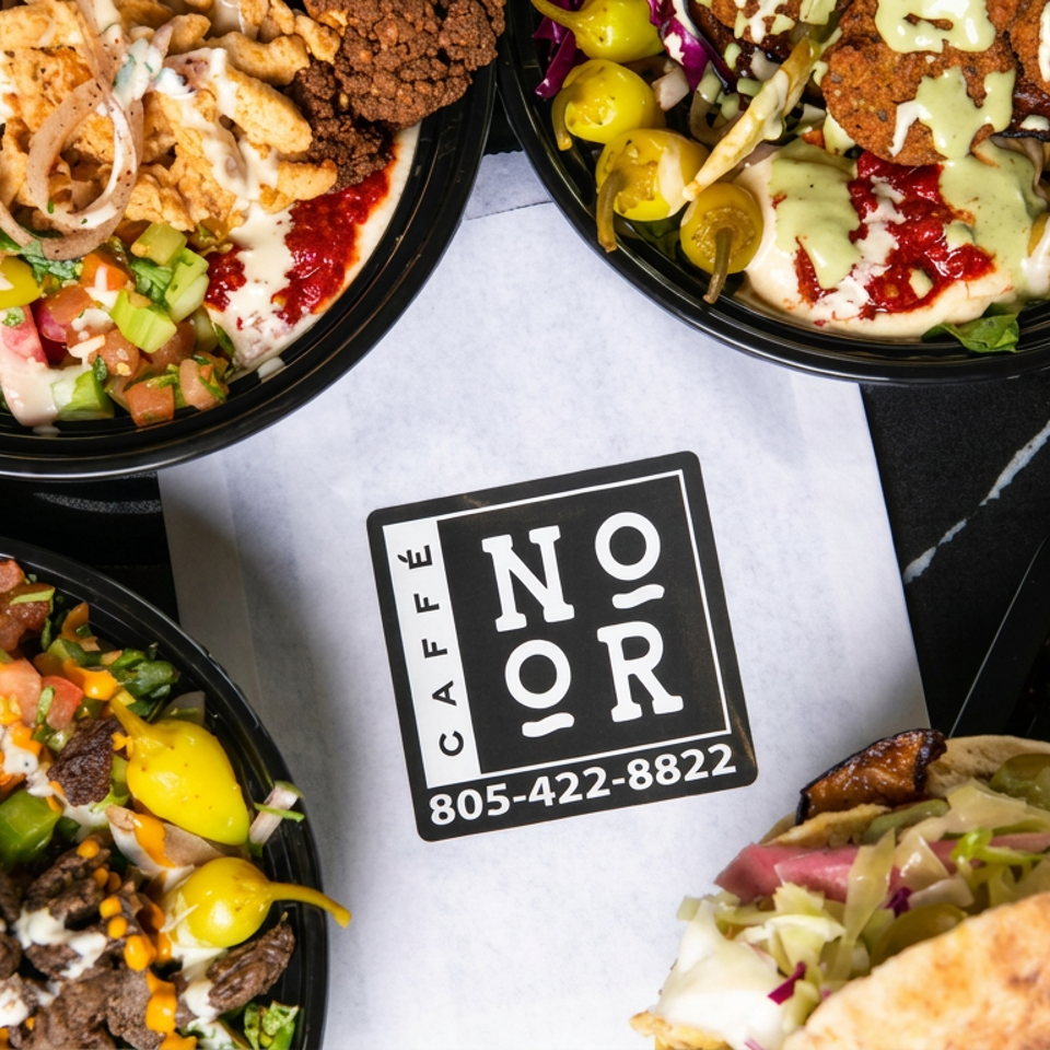 Assorted loaded Mediterranean bowls and stuffed pita sandwiches surround a Café Orion logo on a dark tabletop.